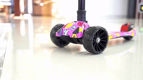 a gif shows a pink child's scooter with cool design