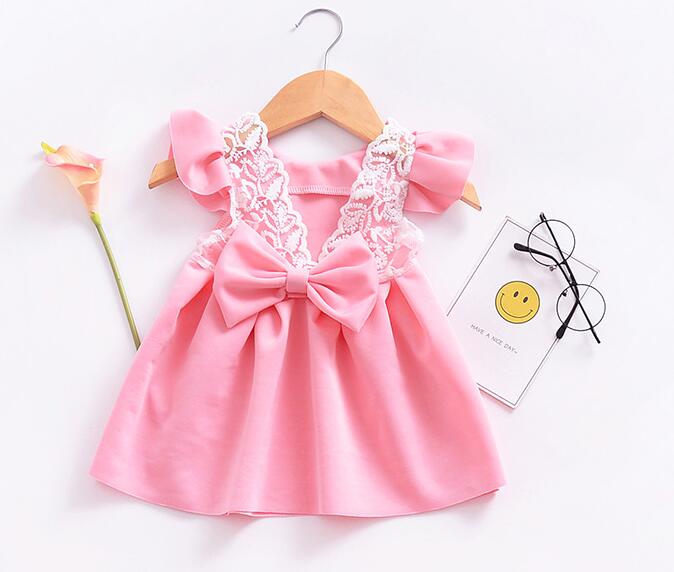 a baby dress in pink with a flower a cute eyeglasses 