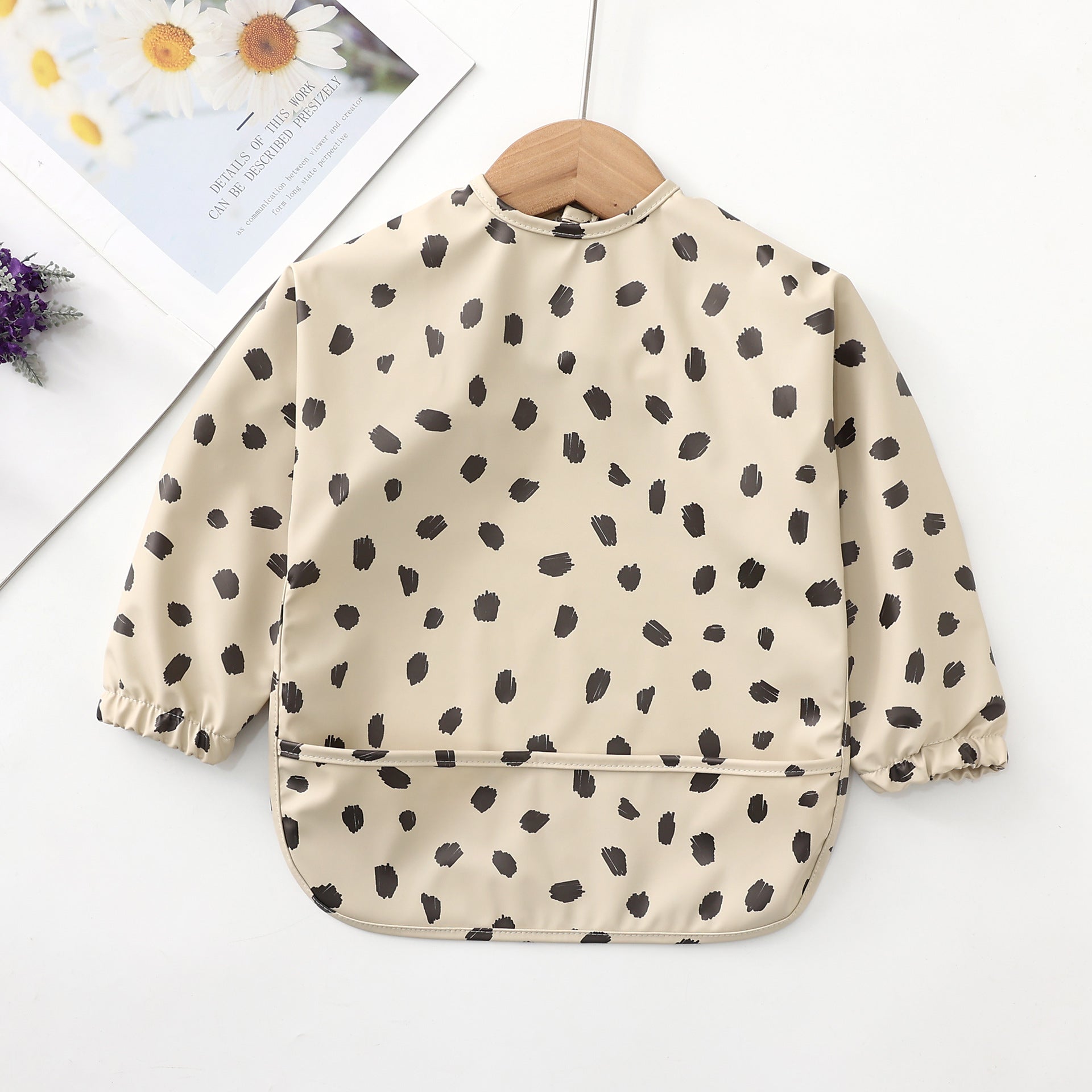 baby girl bib with beige background and black dots 