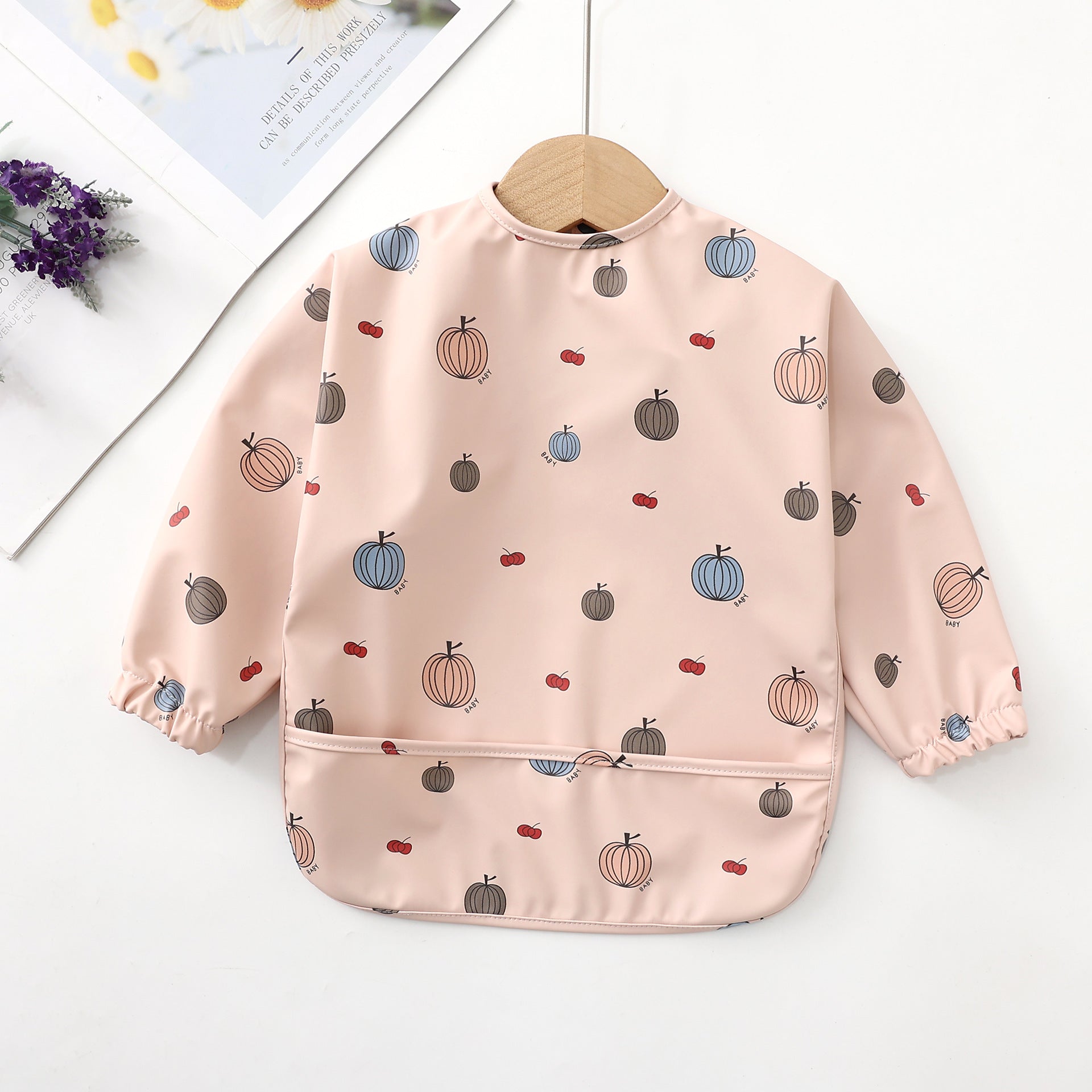 pink colored baby girl bib for eating with pocket and and stretchable cuffs