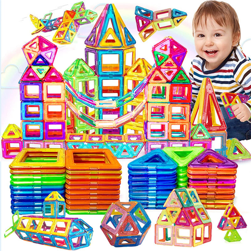 a child is happy with all the things that he has built with the magnetic building blocks