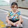a child poses with the printed T-shirt on sale on Kiddle Kart 