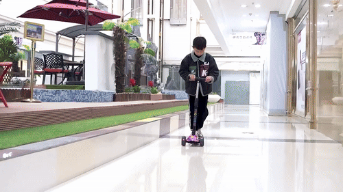 a kid riding pink scooter with glow up lights