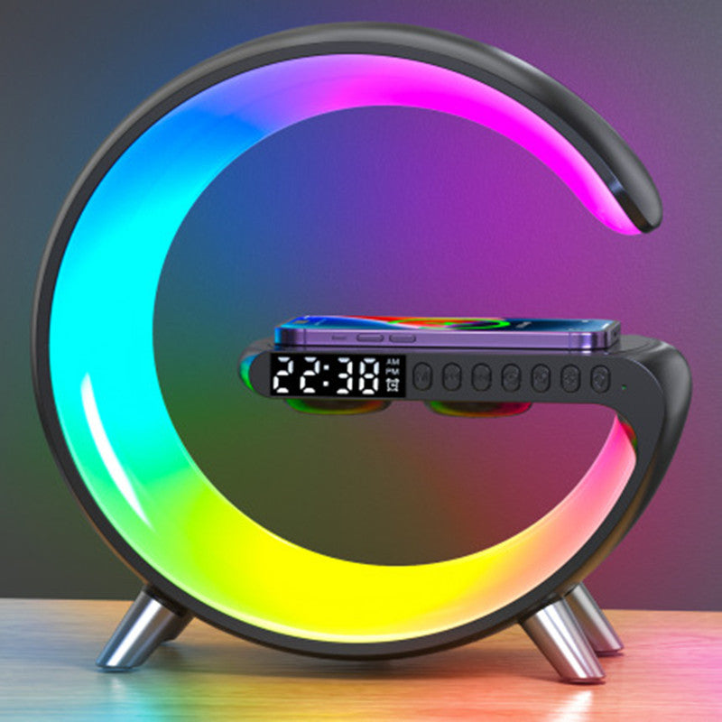 black atmosphere lamp with lighting effects and a phone wirelessly charging
