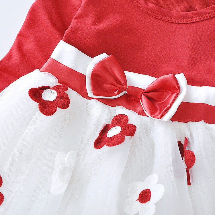the flower bow of the red long sleeve dress