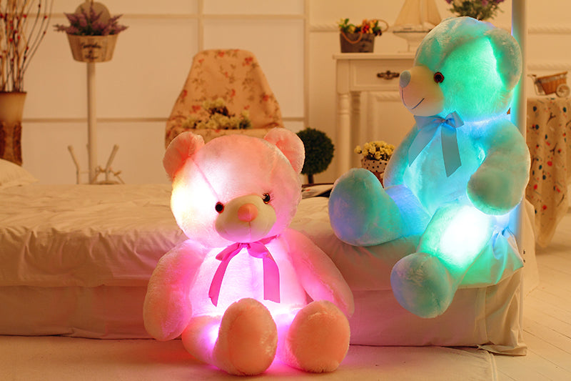 two pink and blue LED light up teddy bears 
